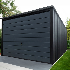Modern dark grey metal garage with horizontal paneling and a large overhead door.