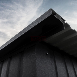 Close-up of a matte black garage roof edge showing corrugated sheet and trim detail.