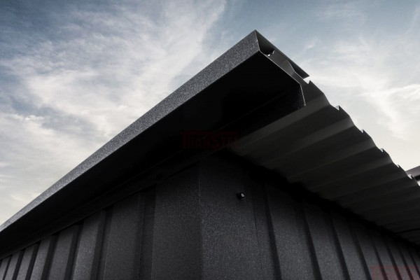 Close-up of a matte black garage roof edge showing corrugated sheet and trim detail.