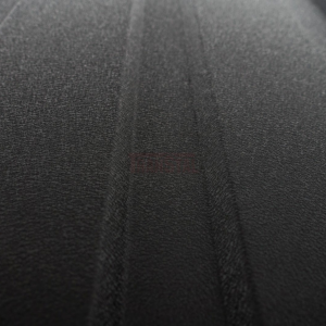 Close-up of matte black corrugated metal siding with a textured finish.