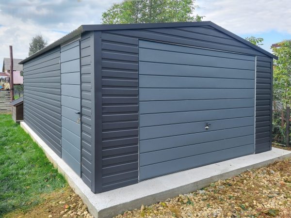 Modern metal garage with horizontal siding, gray color, and a concrete foundation.